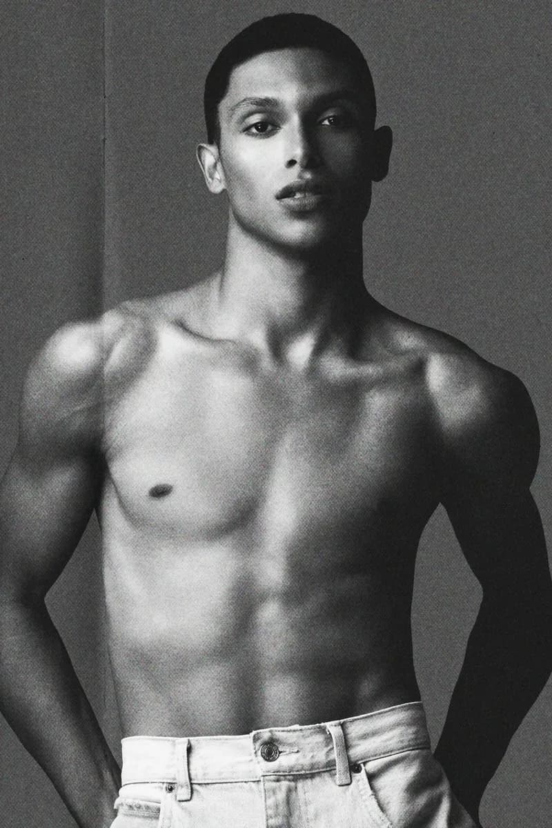 Black and white portrait of a shirtless man in jeans